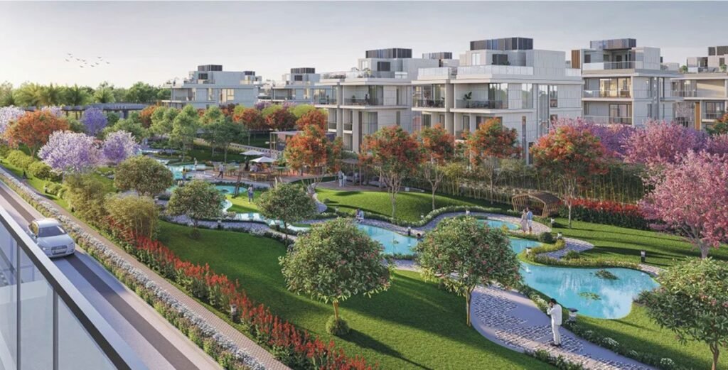 Aerial view of a modern apartment complex with winding water features and lush landscaped gardens.