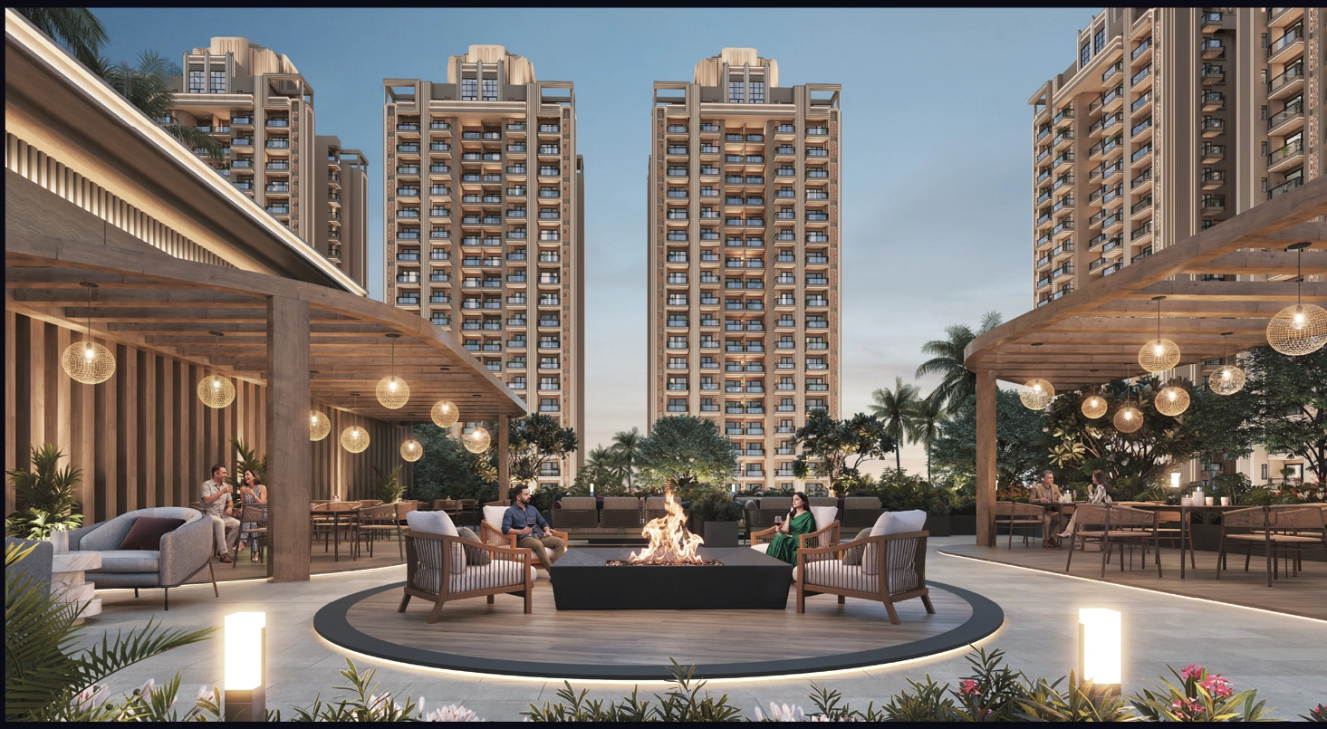 Modern outdoor lounge around a circular fire pit, with comfortable seating and string lights, set against tall beige residential towers.